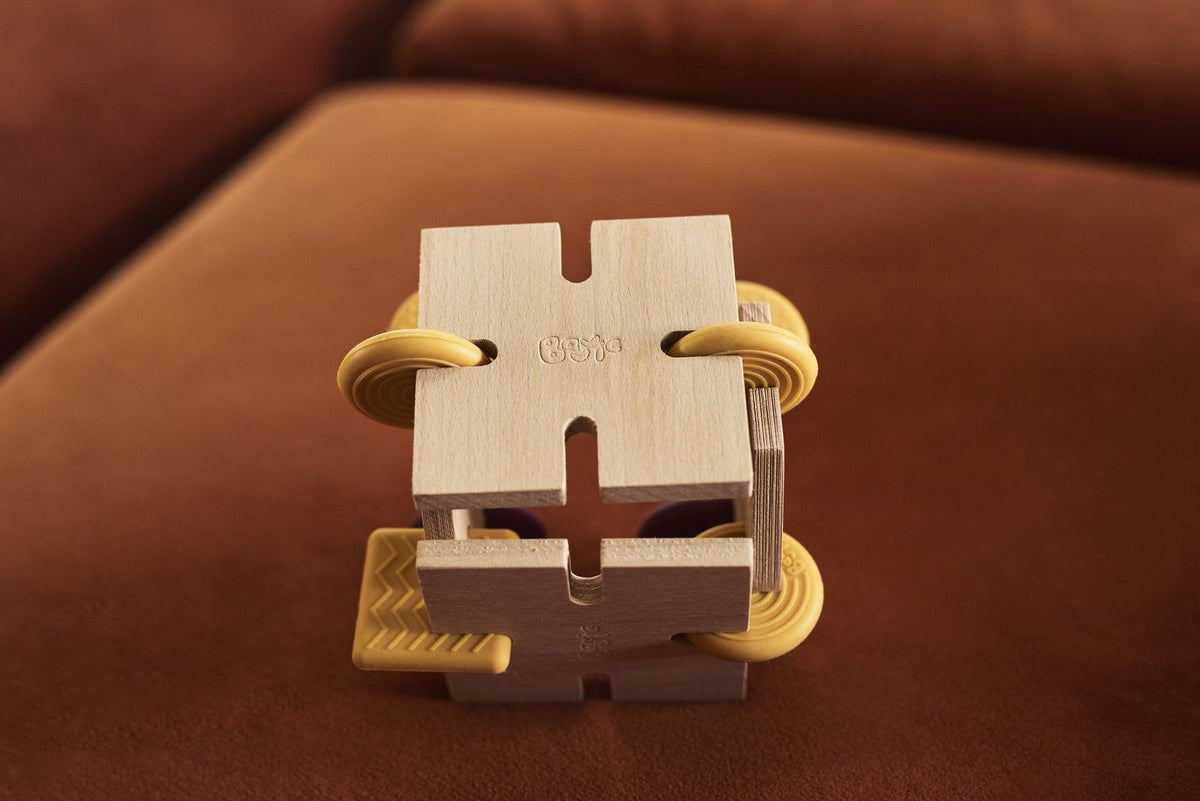 Small desk-sized cube built from BAVVIC beech-wood pieces and yellow silicone connectors